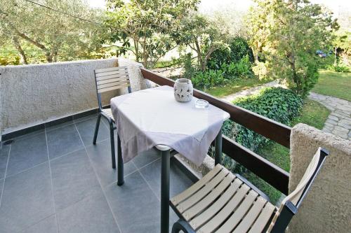a table and two chairs on a balcony at Villa Angela in Vourvourou