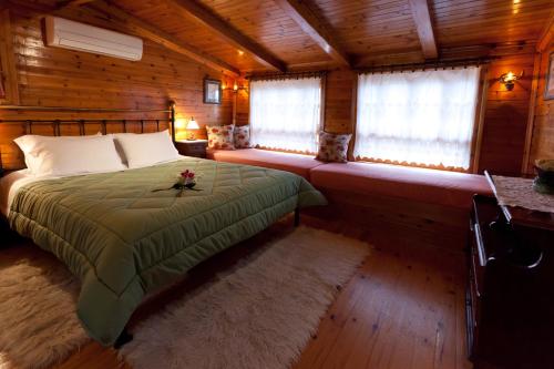 a bedroom with a bed in a wooden cabin at Pension Eleni in Nafplio