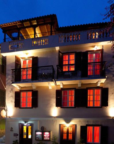 a building with red doors and windows at night at Pension Eleni in Nafplio
