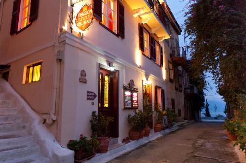 a building with a sign on the side of it at Pension Eleni in Nafplio