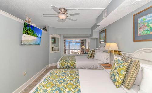 a bedroom with a bed and a ceiling fan at 4th Floor Oceanfront 1 Bedroom Suite! Beach Cove Resort 411 in Myrtle Beach