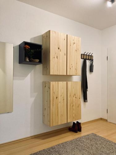 a wooden cabinet on a wall in a room at Schickes, Stilvolles und Helles Apartment in Münster in Münster