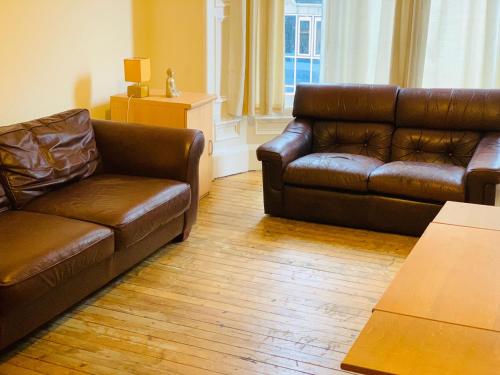 a living room with a couch and a coffee table at Apex Haymarket Apartment in Edinburgh