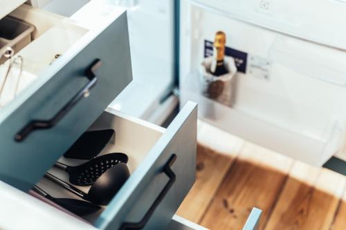 a drawer in a kitchen cabinet with a drawer at Olive Apartment in Liepāja