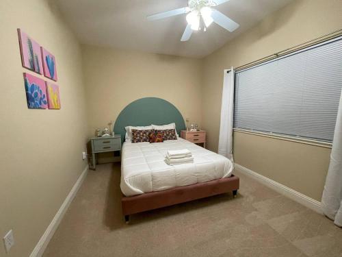 a bedroom with a bed and a ceiling fan at Balmoral in Santa Clara