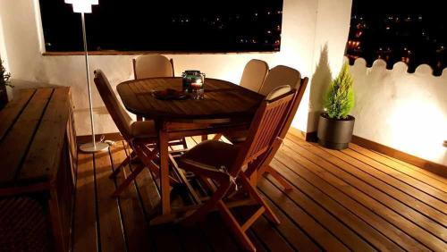 a wooden table and chairs in a room at Casa rural La Rabá Terraza con increíbles vistas in Sanlúcar de Guadiana