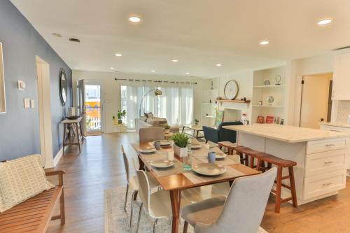 a dining room and living room with a table and chairs at Spacious Waterfront Atlantic City Living with Rec Room in Atlantic City
