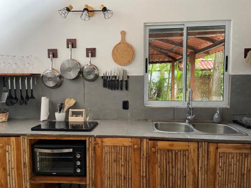 a kitchen with a sink and a counter with utensils at Beach Villa S in Santa Teresa Beach