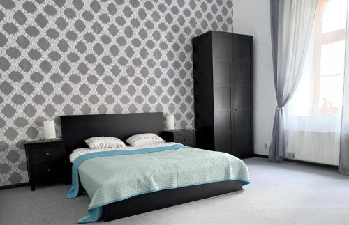 a bedroom with a bed and a wall at NeoApartments - Rynek Pod Gryfami in Wrocław