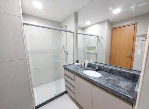 a bathroom with a sink and a shower at LINDO Flat Eco Resort - melhor trecho da praia de Carneiros in Praia dos Carneiros