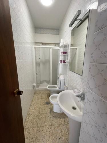 a bathroom with a sink and a toilet and a mirror at Oktheway Perbes Beach Vintage in Boebre