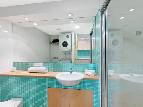 a bathroom with a sink and a shower at The Entrance Waterfront Apartment 621 in The Entrance