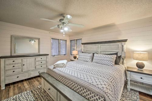 a bedroom with a bed and a ceiling fan at 15 Mi to Hot Springs Natl Park Home with Fire Pit! in Hot Springs Village