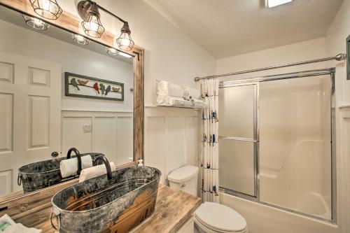 a bathroom with a tub and a shower and a toilet at 15 Mi to Hot Springs Natl Park Home with Fire Pit! in Hot Springs Village