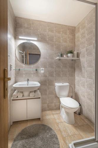 a bathroom with a toilet and a sink at Apartmány MINATA in Liptovský Mikuláš