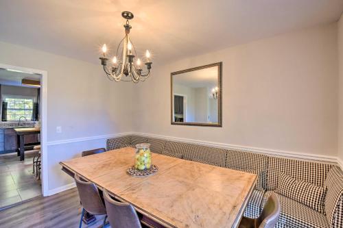 a dining room with a wooden table and a mirror at Mod Stable House on 10 Acres, Walk to Lake! in Oakwood