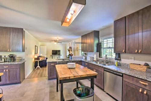 a kitchen with wooden cabinets and a wooden table at Mod Stable House on 10 Acres, Walk to Lake! in Oakwood