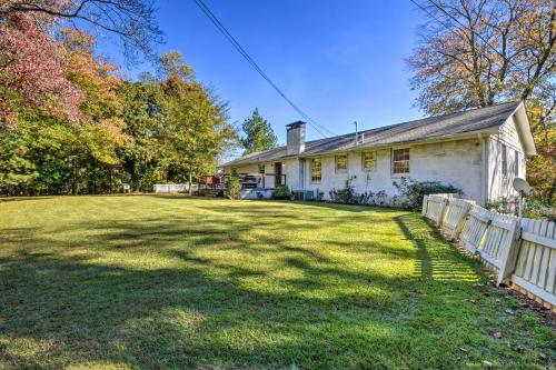 a white house with a fence in the yard at Mod Stable House on 10 Acres, Walk to Lake! in Oakwood