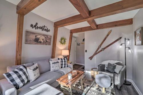 a living room with a couch and a table at 2 Mi to Dtwn Banner Elk! Couples Retreat with Deck in Banner Elk