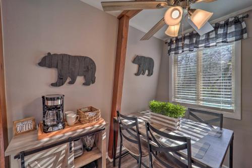 a dining room with a table and chairs and a ceiling fan at 2 Mi to Dtwn Banner Elk! Couples Retreat with Deck in Banner Elk