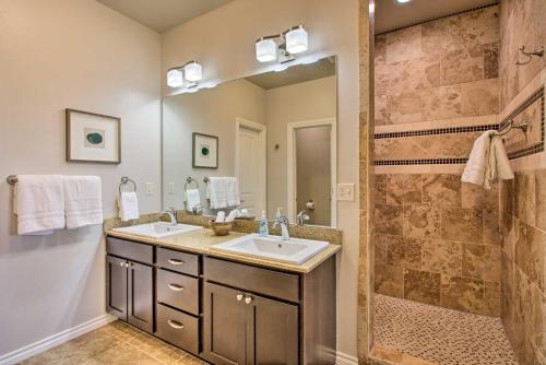 a bathroom with two sinks and a shower at Edmond Oasis with Rooftop Lounge Walk to Dtwn! in Edmond