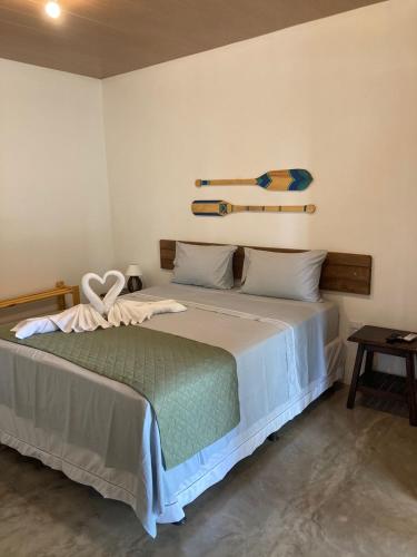 a bedroom with a bed with a heart on it at Club Manguaba Beira Rio Mar in Japaratinga
