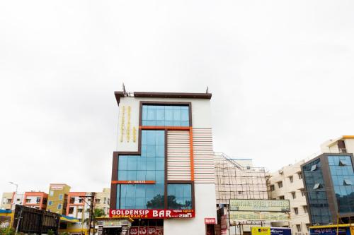 a building with a sign on the side of it at Hotel O Alpine Glow Heights in Hyderabad