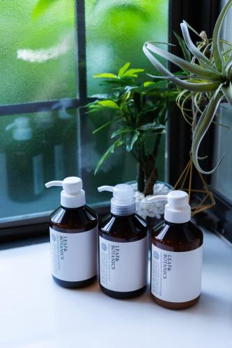 three bottles of liquid sitting on a window sill at 古民家再生ホテル　Relink in Fujiyoshida