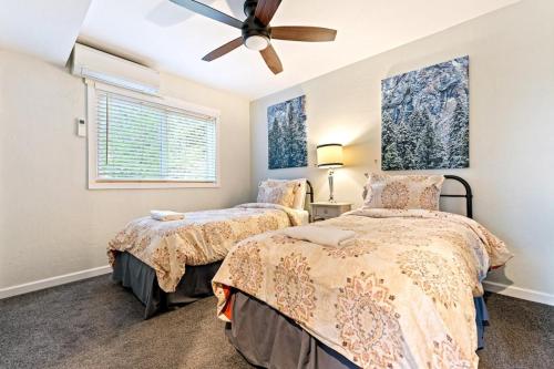 a bedroom with two beds and a ceiling fan at Starfall in Yosemite West