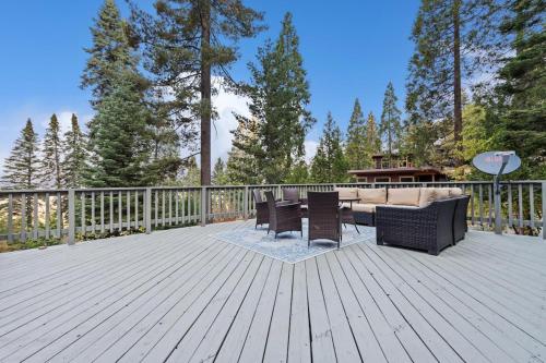 a patio with a couch and chairs on a wooden deck at Starfall in Yosemite West