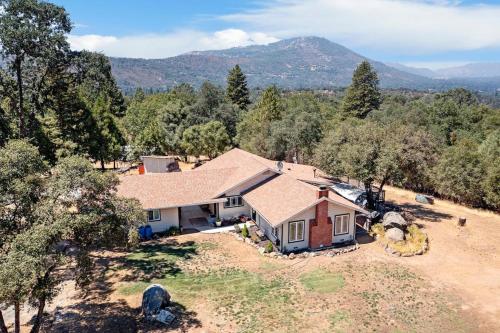 an aerial view of a house with mountains in the background at Bear Den in Oakhurst