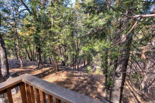 a wooden deck with a view of a forest at Forest Glen in Yosemite West