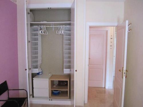 a room with a closet with a white door at Lovely family apartment in high quality residence in Palm-mar