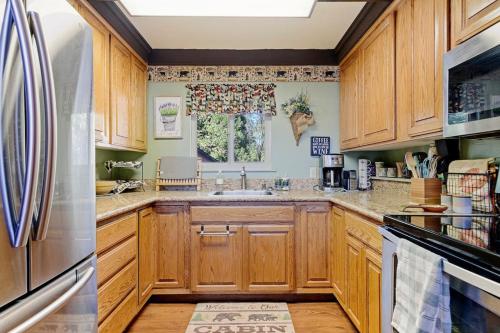 a kitchen with wooden cabinets and a sink at Chief Peak in Fish Camp
