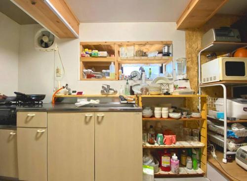 a kitchen with a sink and a microwave at Fukoji in Kawaba