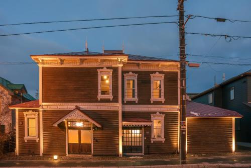 an old wooden house with lights on it at 元町の宿　雪月花 in Hakodate