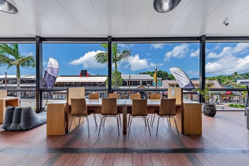 a large dining room with a table and chairs at Airlie Sun & Sand Accommodation #2 in Airlie Beach