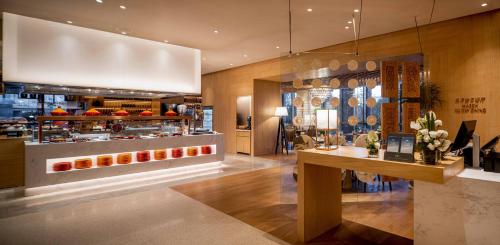 a restaurant with a counter with food in it at Pullman Dali in Dali