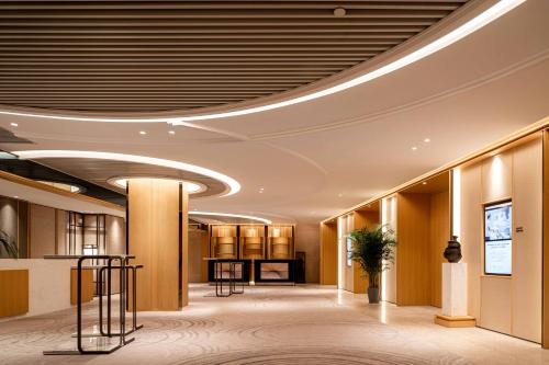 a lobby of a hotel with a ceiling with lights at Pullman Dali in Dali