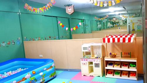 a childs play room with a toy refrigerator at Shianghu Boutique Hotel in Chiayi City
