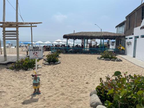 a sign on a beach with a no tacos sign on it at Hamacas in Punta Negra