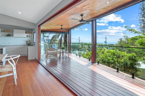 a kitchen and dining room with a deck with a view at Luxe Coastal Abode, Marcus Beach in Marcus Beach