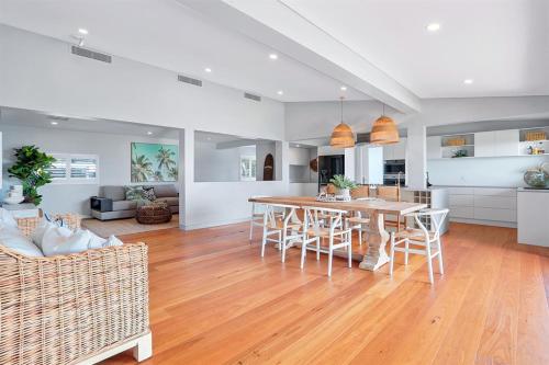 a kitchen and living room with a table and chairs at Luxe Coastal Abode, Marcus Beach in Marcus Beach