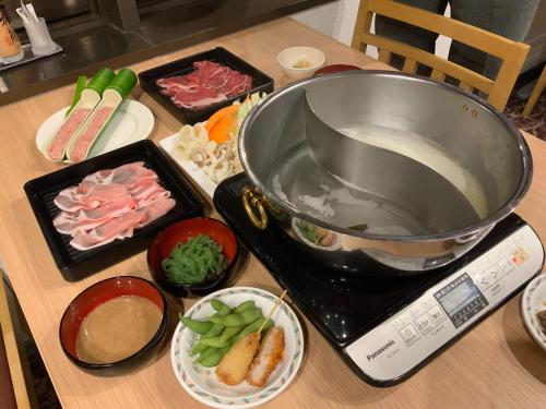 a kitchen counter with a mixer and some food at Myogi Green Hotel in Tomioka