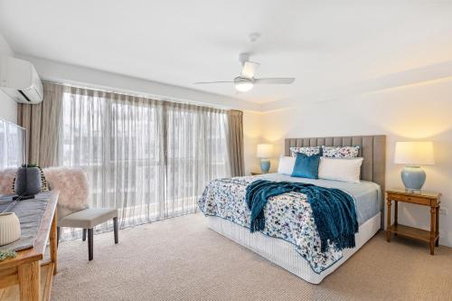 a bedroom with a bed and a window at Solnamara Beachfront Apartments in Gold Coast