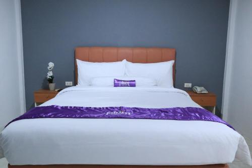 Postel nebo postele na pokoji v ubytování Plum Hotel Lading Banda Aceh