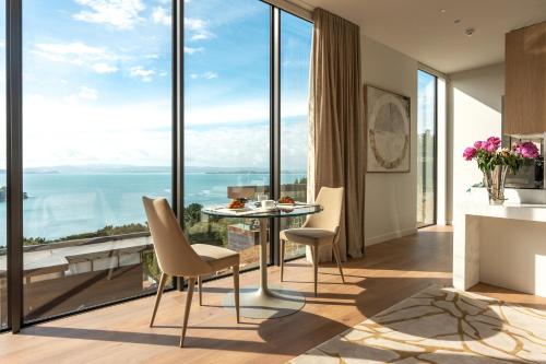 a dining room with a view of the ocean at Omana in Rocky Bay