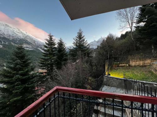 a balcony with a view of a snow covered mountain at 4 Seasons Tzoumerka Life in Melissourgoi