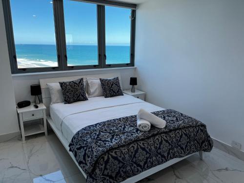 A bed or beds in a room at Beachfront Towers