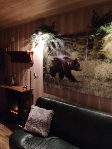 a painting of a bear on a wall in a living room at Marynka in Zakopane